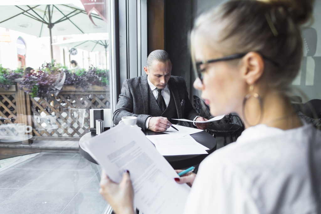 beautiful-young-woman-checking-documents-caf.jpg